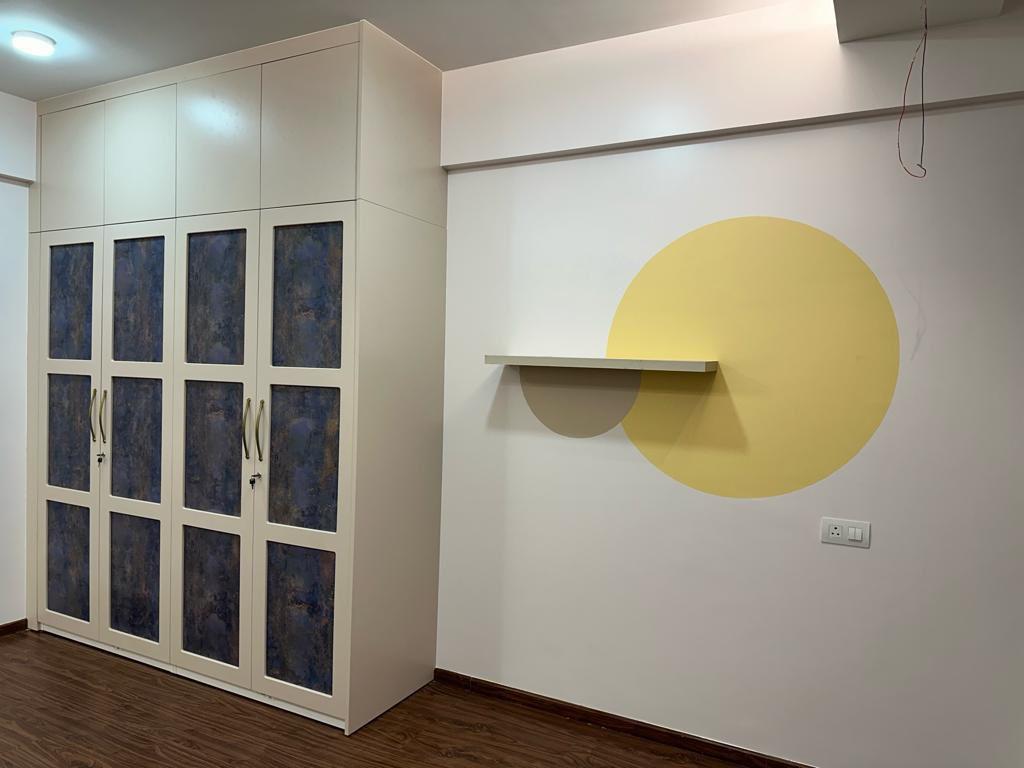 Finished bedroom interior with two tone wardrobe and circular accent wall shelf