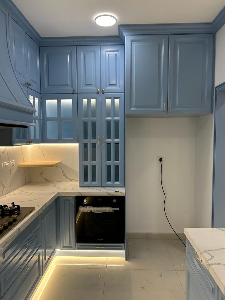 Premium classic modular kitchen with pastel blue shaker cabinets and white marble backsplash